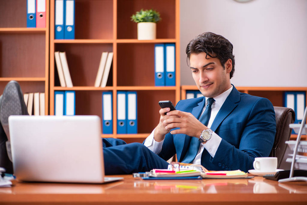 Young handsome businessman working in the office - Photo, image