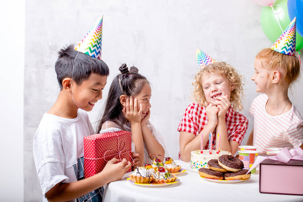funny little girl is waiting for gifts for her birthday - Photo, Image