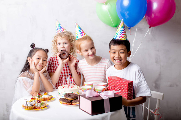 boy is celebrating his birthday with girls - Foto, afbeelding