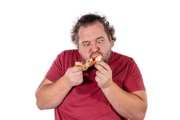 Funny fat man eating croissant - Photo, Image