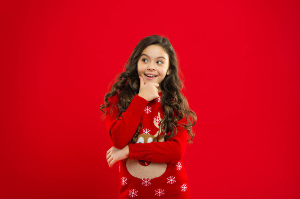New year party. Santa claus kid. Little girl child in santa red hat. Christmas shopping. Present for Xmas. Childhood. Happy winter holidays. Small girl. what will we do - Photo, Image
