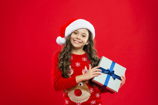 Present for Xmas. Childhood. Happy winter holidays. Small girl. New year party. Santa claus kid. Christmas shopping. Little girl child in santa red hat. present for new year - Photo, image