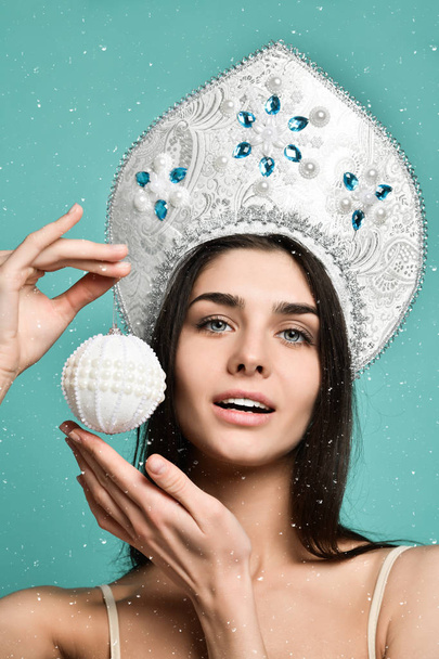 Christmas Woman. Cute Face. Healthy Skin. girl holds in her hand a Christmas tree ball. - Foto, Bild