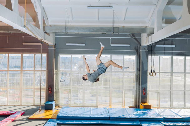 young active guy performing the flips - 写真・画像