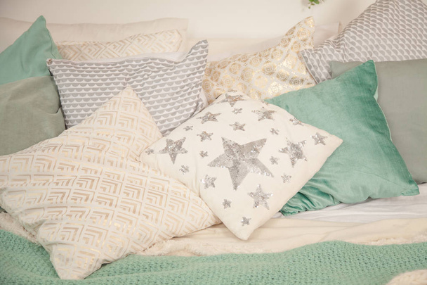beautiful cute light pillows lie on the bed in the room - Photo, Image