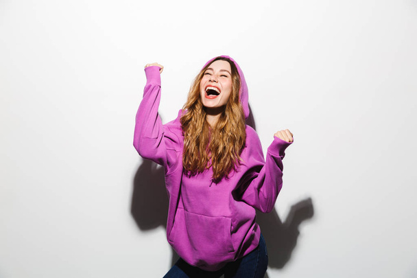 Portrait of joyous pretty woman 20s wearing sweatshirt laughing isolated over white background - Fotó, kép