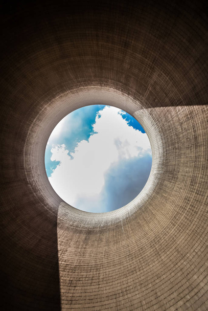 View up a coal burning power plant cooling tower with clouds and sunshine - Photo, Image