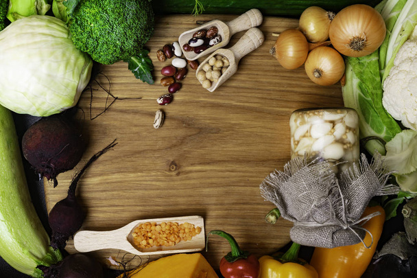 Verse groenten en peulvruchten in houten plank. Biologisch voedsel. Vegan voedingsmiddelen en nieuwe voedselingrediënten. Gezond eten ruimte van de kopie van het concept - Foto, afbeelding