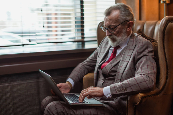 Fashionable elderly male writer wearing elegant clothes working  - Zdjęcie, obraz