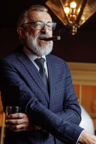 Elderly businessman in formal suit with whiskey and cigar at lux - Fotografie, Obrázek