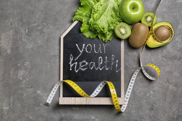 Flat lay composition with blackboard and fruits on gray background. Weight loss - Φωτογραφία, εικόνα