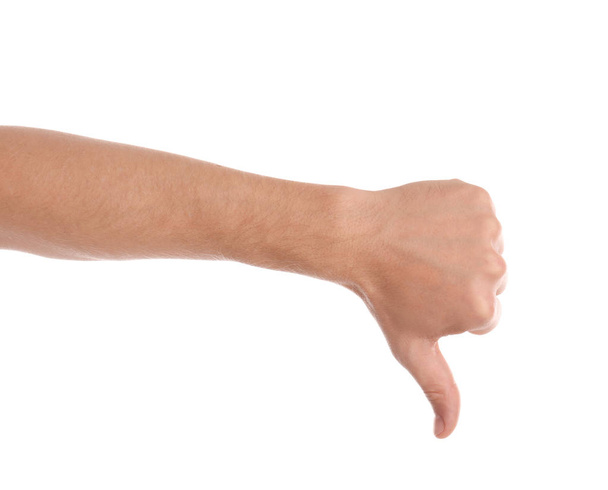 Man showing thumb down gesture on white background, closeup of hand - Valokuva, kuva