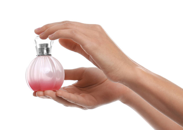 Young woman with perfume bottle on white background, closeup - Foto, Imagem