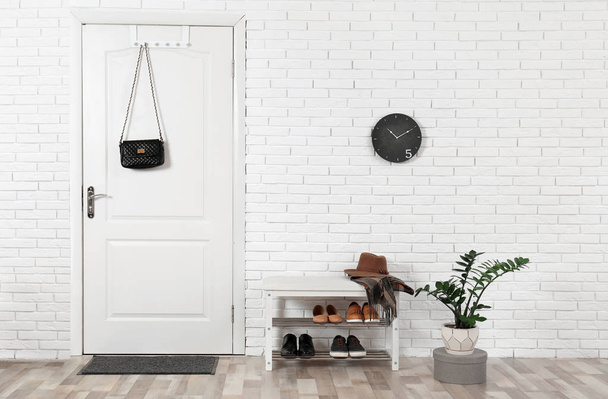 Hall interior with brick wall and white wooden door - Foto, immagini