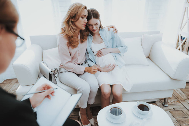 Mother with Pregnant Daughter in Doctor Office. Visit to Family Doctor. Consulting Psychologist. Healthy Pregnancy Concept. Young Mother. Worried Mother. Pregnant Girl. Psychological Help. - Φωτογραφία, εικόνα