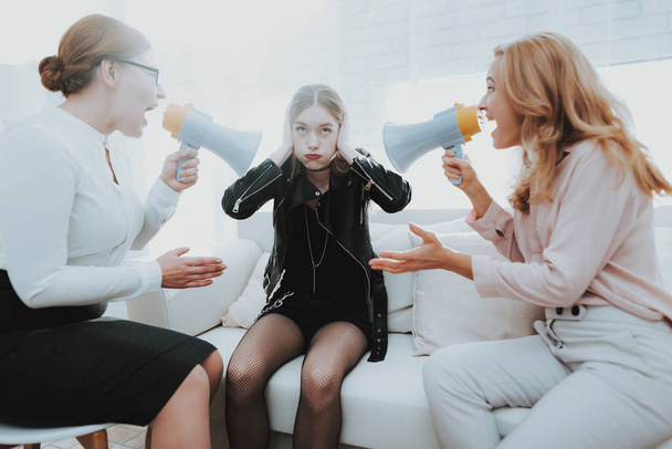 Upset Teenage Daughter in Jacket in Psychologist Office with Mother. Punk in Lather Jacket. Communication Concept. Psychotherapy Concept. Puberty Problems. Conflict in Family. Family Doctor. - 写真・画像