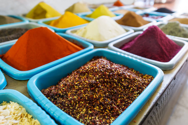 Various eastern spices and seasonings for different dishes in the shop. Closeup photo - Foto, imagen