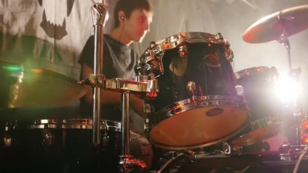 Young man emotionally playing drums in a rock band - Footage, Video