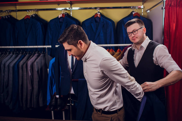 man is buying suit in store - Foto, immagini