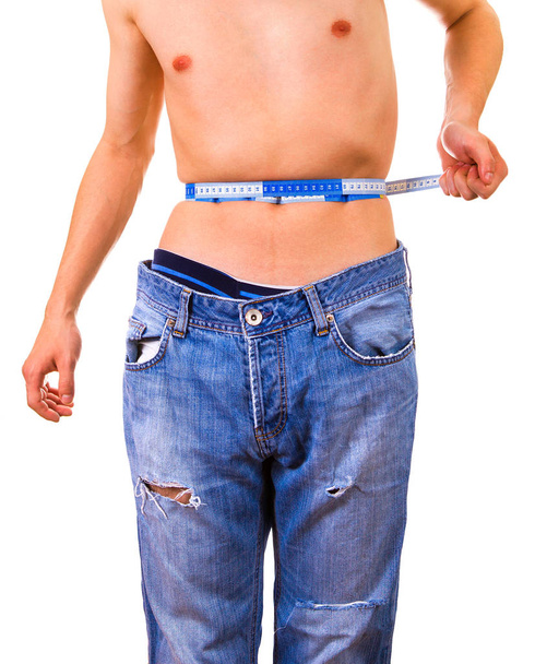 Skinny Man measure his Waist on the White Background - Foto, imagen