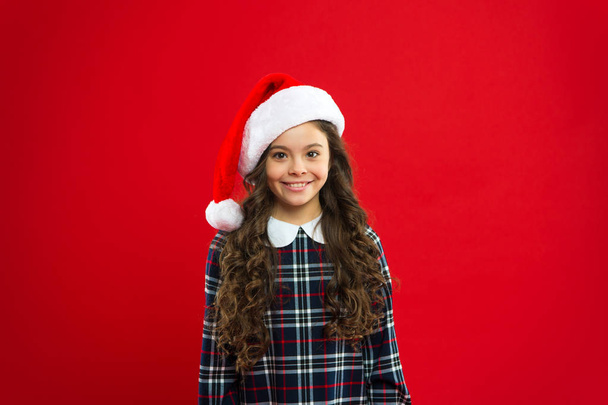 Happy winter holidays. Small girl. Present for Xmas. Childhood. New year party. Santa claus kid. Christmas shopping. Little girl child in santa red hat. Typing message to elfs. Little cute elf - Photo, Image