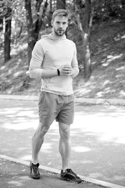 sportsman. sportsman training in park. muscular sportsman relax after training. fashion sportsman on road in forest. getting ready for running. - Foto, imagen