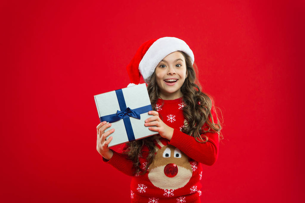 Happy winter holidays. Small girl. Little girl child in santa red hat. Present for Xmas. Find presents online. Childhood. Christmas shopping. New year party. Santa claus kid. Cyber monday - Φωτογραφία, εικόνα