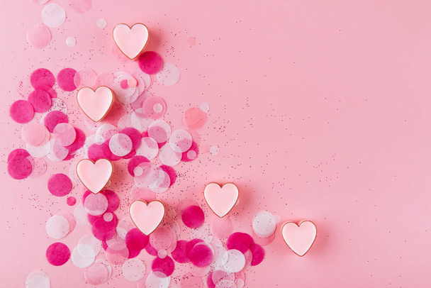 heart with confetti on pink background. Top view - Фото, изображение