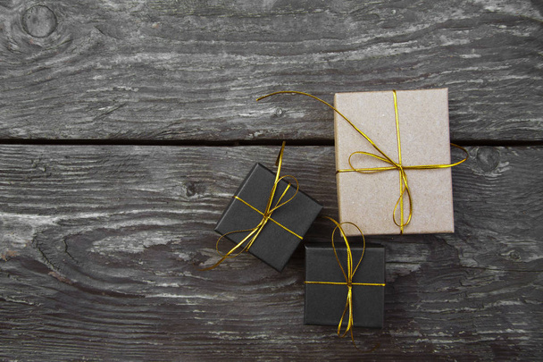 Christmas gift boxes on a rustic wooden background - Fotoğraf, Görsel