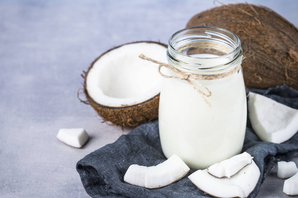 Coconut milk in glass jar. Vegan non dairy milk.  - Photo, Image
