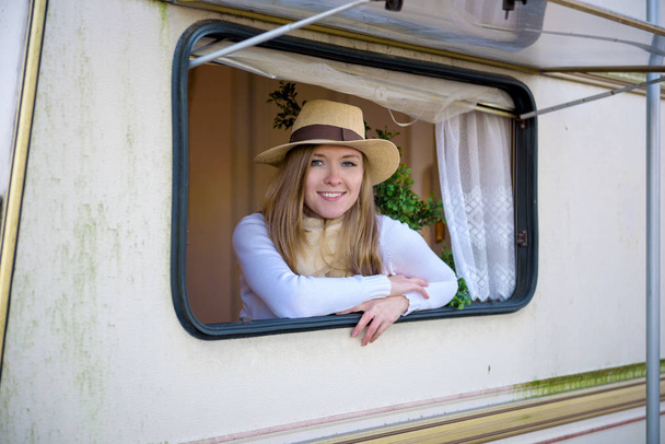 Beautiful young woman in a camper van on a summer day - Foto, Imagen