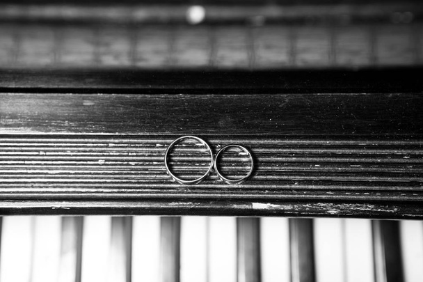 Wedding rings on piano black and white - Photo, Image