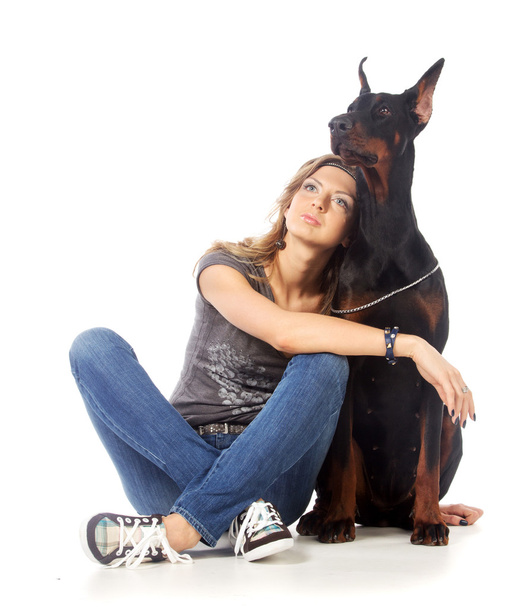 Young woman with black dobermann dog - Zdjęcie, obraz