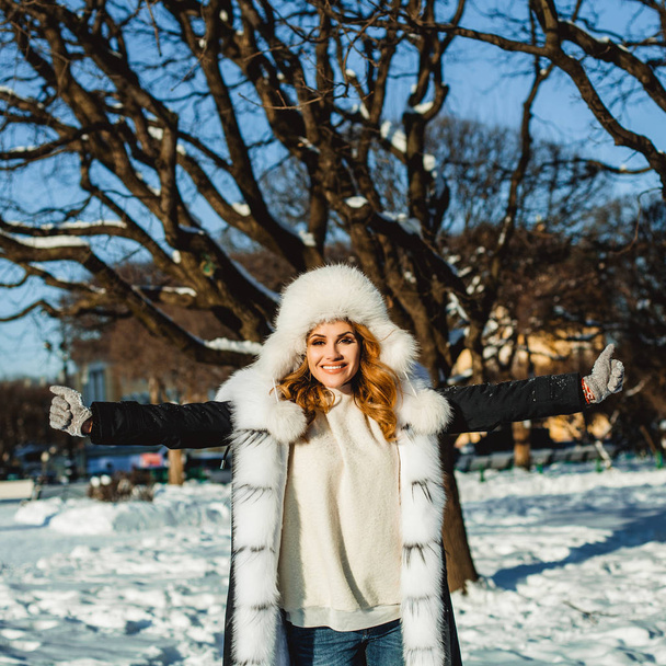 Cheerful woman in winter park outdoors - Photo, Image