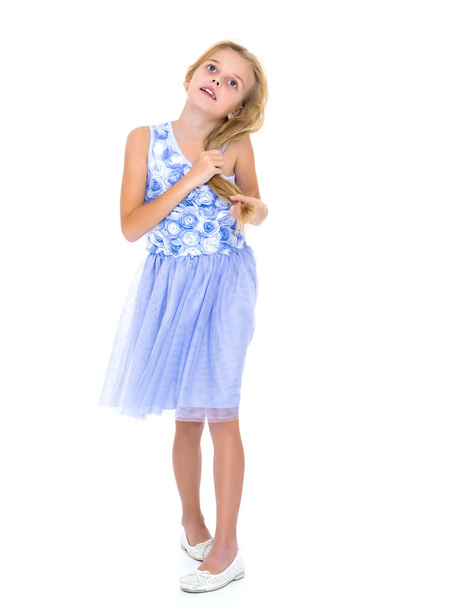 Little girl in a dress developing in the wind. - Фото, зображення