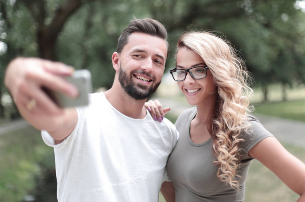 close up.smiling young couple taking selfie in city Park - Fotó, kép