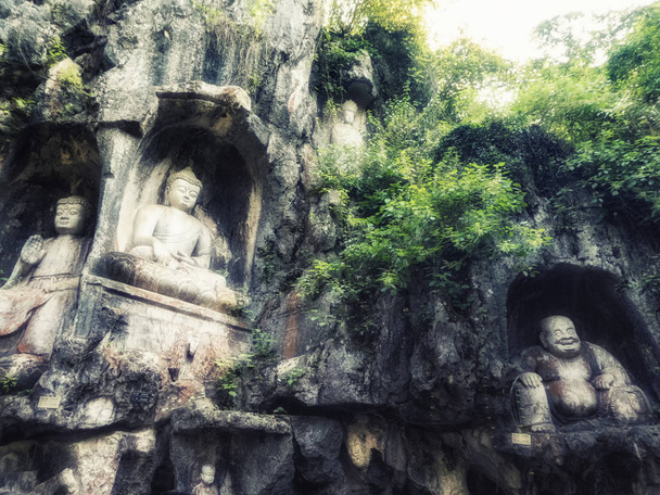 Grutas Feilai Feng com belas esculturas de pedra budista. Chama-se "o pico que voou até aqui" ou "Pico Voador" e está localizado em frente ao templo de Lingyin
. - Foto, Imagem