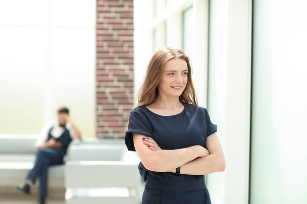 confident young businesswoman standing near the office window. - Foto, afbeelding