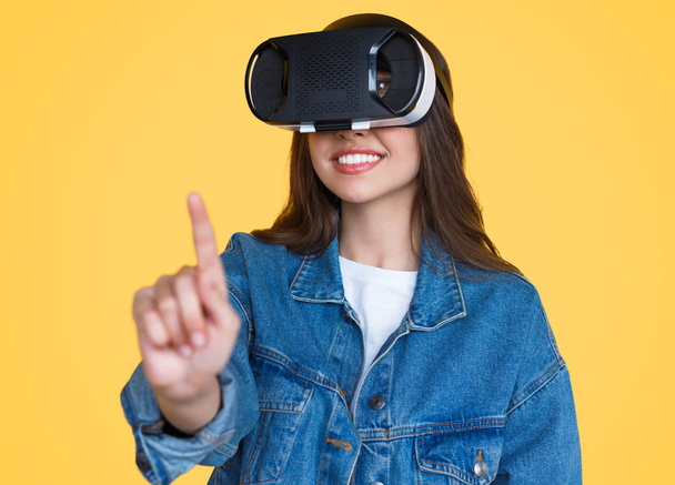 Modern woman in VR glasses touching air - Fotoğraf, Görsel
