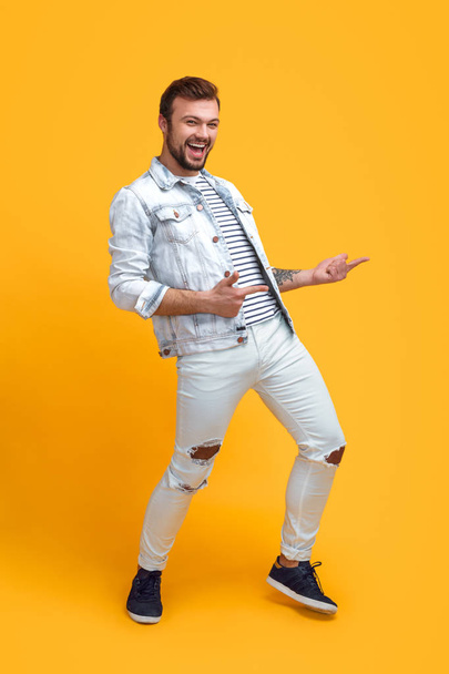 Trendy hipster man pointing away in dance - Фото, изображение