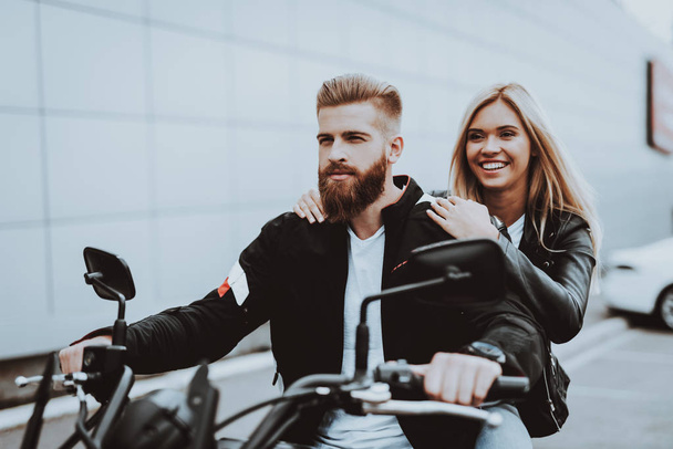Man And Women Are Sitting On Motorcycle. Going For Ride. Fashion Riders. Confident Staring. Speed Vehicle. Biker With A Beard. Motorbike Concept. Classic Style. Ready To Drive. Tripping Together. - Foto, afbeelding
