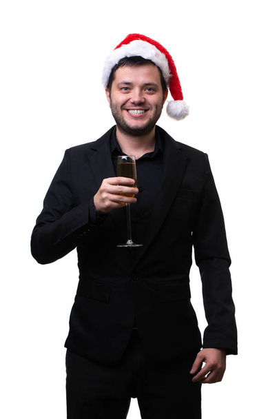 Photo of happy man in santa hat with glass of champagne in his hands - Zdjęcie, obraz