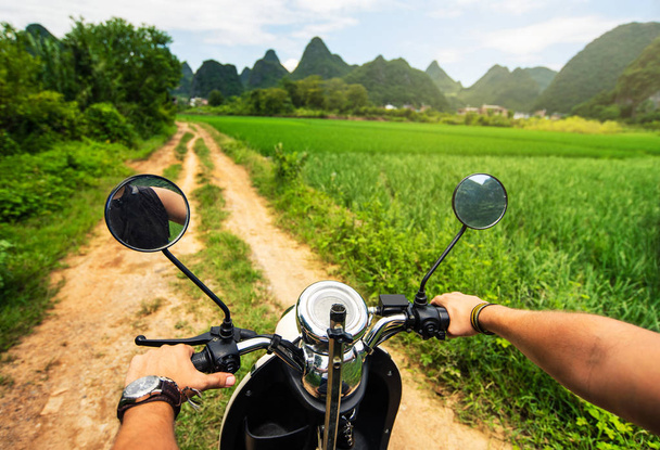 Traveler riding motorbike on Asian trip first person view - Photo, Image