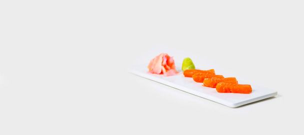 Sushi on a white plate on a white background isolated - Fotó, kép
