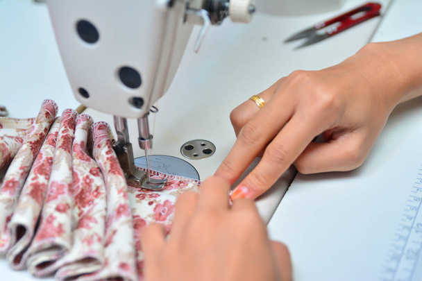Seamstress working on sewing machine - 写真・画像