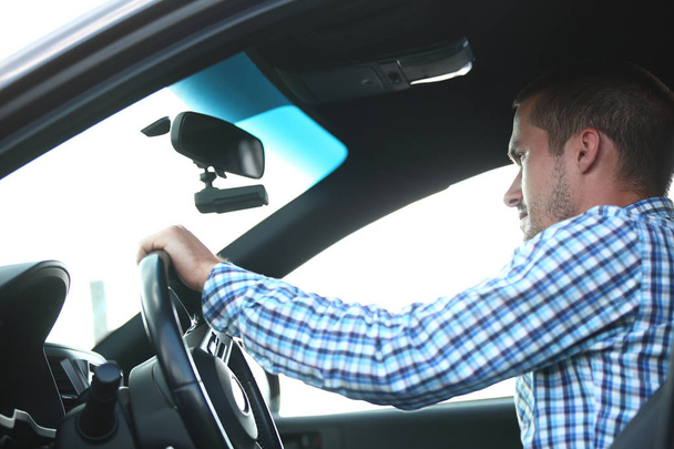 young successful man sitting behind the wheel of a car - Фото, зображення