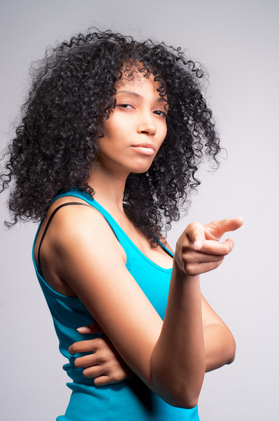 mulatto woman pointing her finger. - 写真・画像