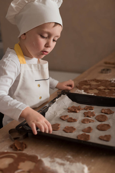 Baby Makes Christmas Cookies. Culinary Concept. Christmas Cooking. Children - Foto, imagen