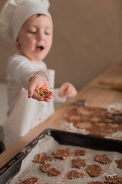 Baby Makes Christmas Cookies. Culinary Concept. Christmas Cooking. Children - Foto, imagen