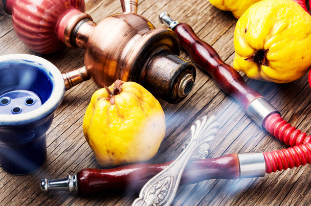 Smoking hookah with mouthpieces with quince flavor.Shisha advertising - Foto, immagini
